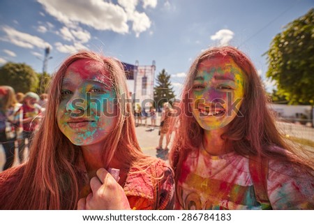 KALININGRAD, RUSSIA - JUNE 12, 2015: People with painted faces during the Holi Festival of Colors. Holi is a festival celebrated as a festival of colours