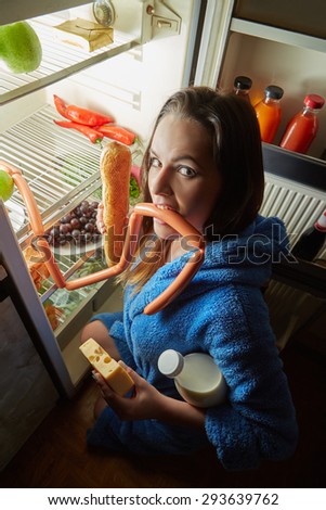 hungry woman eating food near refrigerator