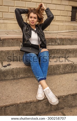 pretty woman with long hair sitting on steps