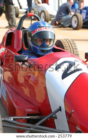 Racing driver in Formula Ford racing car at Castle Combe racing circuit