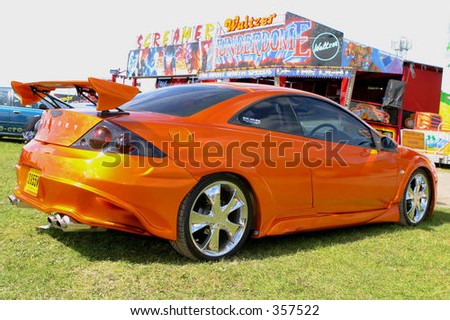 Modified sportscar by fairground ride