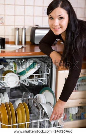 attractive brunette woman cleaning kitchen