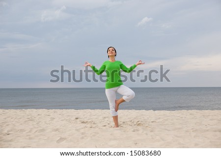 active woman doing exercise on the beach