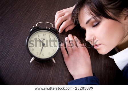 attractive brunette and tired woman with clock