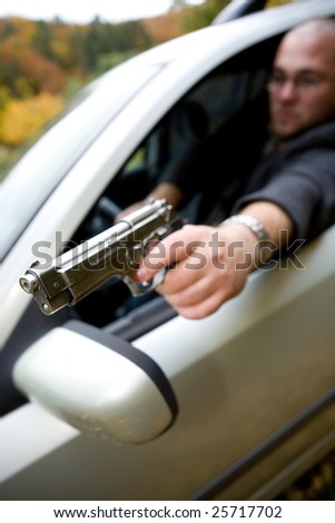 angry man with gun driving car