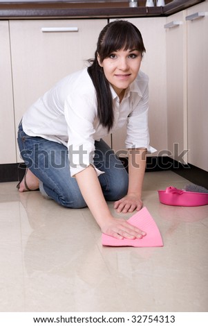 young brunette woman cleaning kitchen