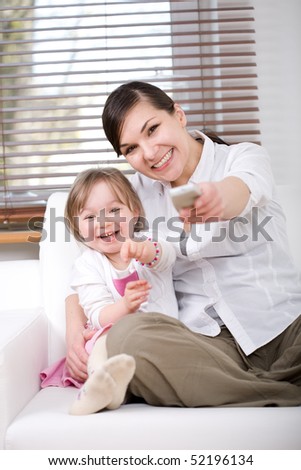 mother and daughter having fun on sofa