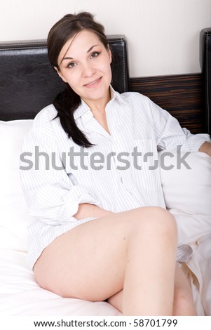 young adult brunette woman in bed