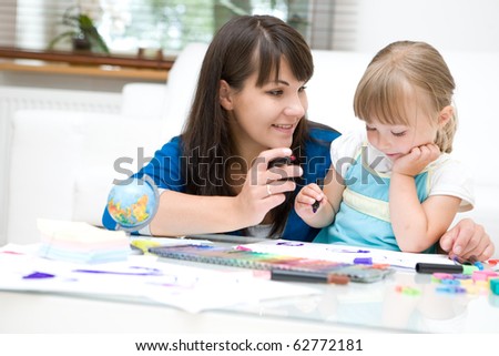 mother and daughter having fun in kindergarten