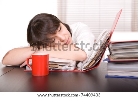 young adult over-worked woman at desk