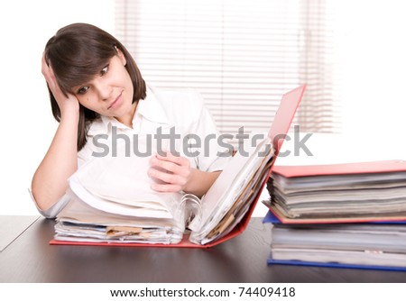 young adult over-worked woman at desk