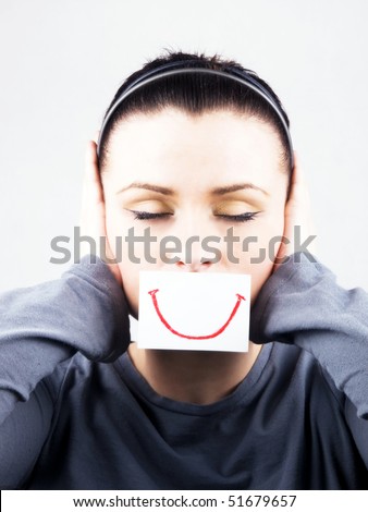 stock photo : Portrait of beautiful young woman with fake smile. She's cover ears.