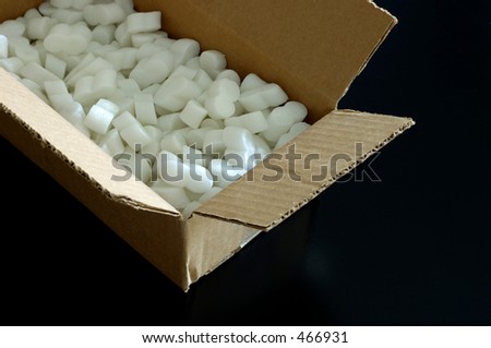 Open cardboard box with packing styrofoam peanuts inside