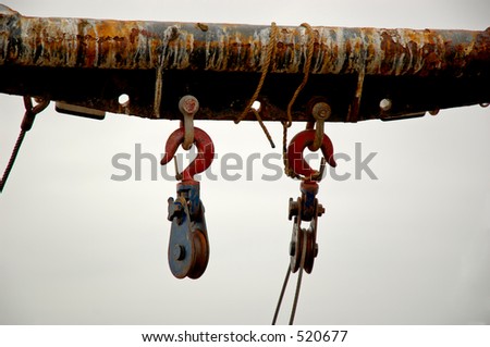 Old and rusty heavy duty hooks on ship.