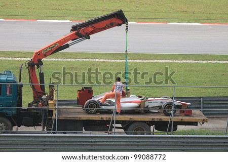 SEPANG, MALAYSIA - MARCH 23: A Team HRT F1 car towed back to the pits after an accident during Friday practice at Petronas Formula 1 Grand Prix March 23, 2012 in Sepang, Malaysia