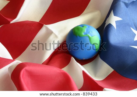 Globe on American flag. Illustrative of world superpower, economy, commerce, freedom, democracy, etc. Other versions available.