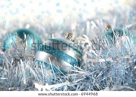 Shiver and Shine: Blue stars dance and twinkle around cool blue and silver ornaments nestled among some coordinating garland with space for copy.