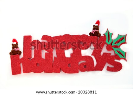 Two fuzzy bears sit a top a glittering holiday greeting isolated against a white background.