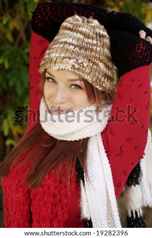 A beautiful woman with a red hair, red scarf, and red top.