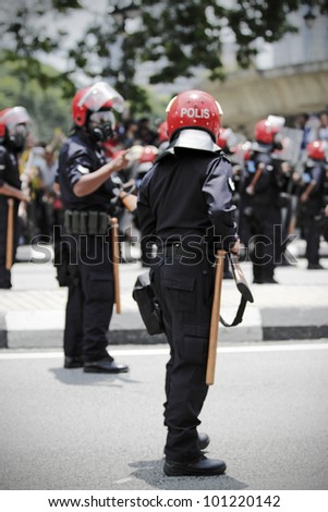 KUALA LUMPUR, MALAYSIA - APRIL 28: Riot police with gas mask at the protest rally organized by the coalition for clean and fair election on April 28, 2012 in Dataran Merdeka, Kuala Lumpur, Malaysia.