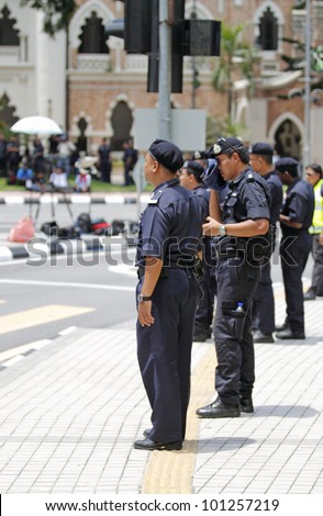 KUALA LUMPUR, MALAYSIA - APRIL 28: Policeman on sentry at the protest rally organized by the coalition for clean and fair election on April 28, 2012 in Dataran Merdeka, Kuala Lumpur, Malaysia.