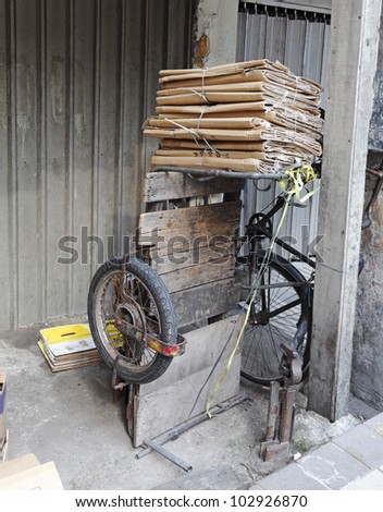 A vintage old tricycle used by scrap collector parked along the corridor of an old shop in Kuala Lumpur Chinatown in Malaysia.