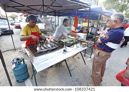 SUBANG JAYA, MALAYSIA - JULY 22: Food vendor at a Ramadan food bazaar on July 22, 2012 in Subang Jaya, Malaysia. The food bazaar is establish for muslim to break fast during the holy month of Ramadan.