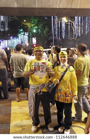 KUALA LUMPUR, MALAYSIA - AUGUST 30: Protesters with slogan phamplet at the street rally organized by the Alliance of NGO for democracy in Dataran Merdeka on August 30, 2012 in Kuala Lumpur, Malaysia.