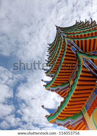 Exotic colorful oriental pagoda against a blue cloudy sky. This is a HDR image.