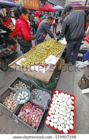 SUZHOU, CHINA - NOV 6: Shoppers purchase farm produce on November 6, 2012 in Shantangjie, Suzhou, China. Shantangjie is a 1100 year old historic market street build in 825 AD in the Tang Dynasty.
