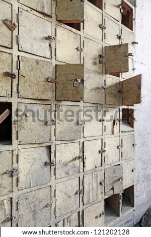 Facade of an old vintage timber postal box with locks and latch.