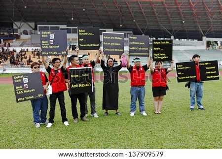 PETALING JAYA, MALAYSIA - MAY 8: Protester with political placard at a political rally against the Malaysia 13th general election vote result on May 8, 2013 in Stadium MBPJ, Petaling Jaya, Malaysia.