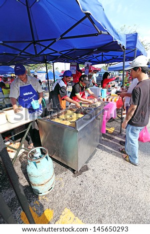 SHAH ALAM, MALAYSIA - JULY 11: Food vendor at a Ramadan food bazaar on July 11, 2013 in Shah Alam, Malaysia. The food bazaar is established for Muslim to break fast during the holy month of Ramadan.