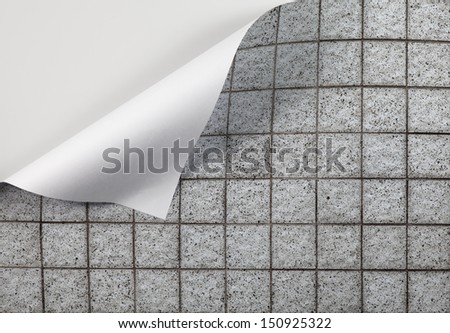 A weathered granite mosaic tile flooring with a fold at the edge with blank space for text.
