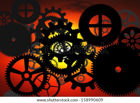 Abstract pattern of industrial gear wheel against blazing forge fire.