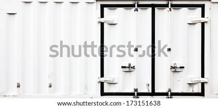 Metal doors with latches on the side of an industrial refrigerated cargo container with blank space for text.