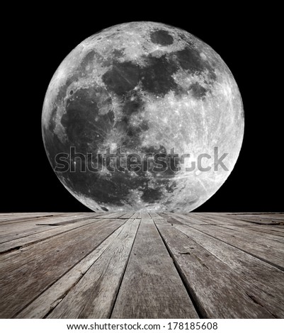 A supermoon on a clear night in the horizon of an empty timber deck platform. Element of this image furnished by NASA.
