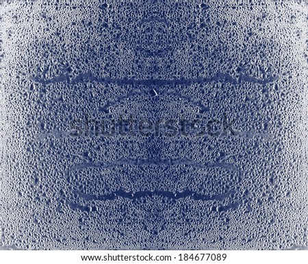 Cold water condensation droplets on a glass pane for textural background.