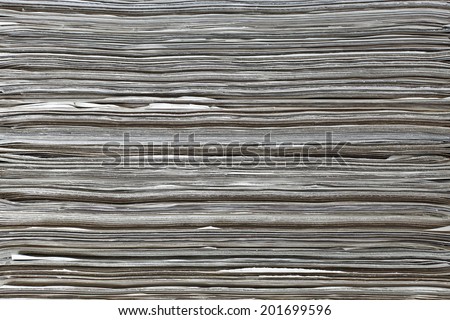 Facade of a stack of newspaper for textural background.