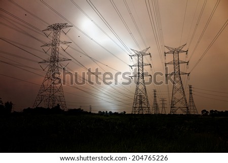 Lightning strike at an electric power line across a rural landscape.