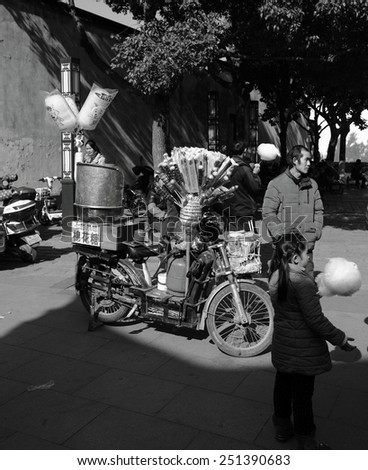 TONGLI, CHINA - JANUARY 2, 2015: A candy vendor in the ancient town of Tongli, China. The town is placed under China National Key Cultural Relic Protection Unit.