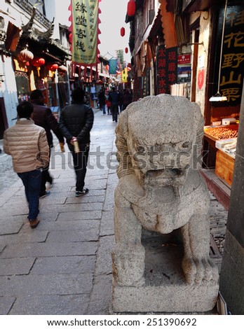 TONGLI, CHINA - JANUARY 2, 2015: Ancient statue of mythological creature known as Qilin in the ancient town of Tongli, China. The town is placed under China National Key Cultural Relic Protection Unit