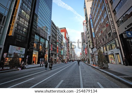 TOKYO - DECEMBER 21, 2014: Shoppers on the main street at Ginza Shopping district in Tokyo, Japan. Ginza is recognized as one of the most luxurious shopping districts in the world.