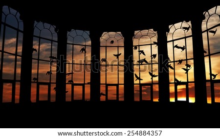Silhouette flocks of birds flying in a surreal candy-color sunset sky outside a bay window frame.