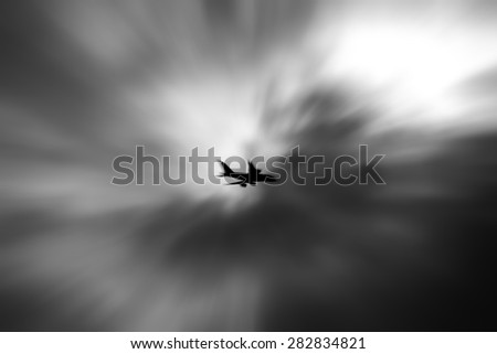 Silhouette of an airplane in the vortex of a psychedelic storm cloud for the concept of danger in flying.