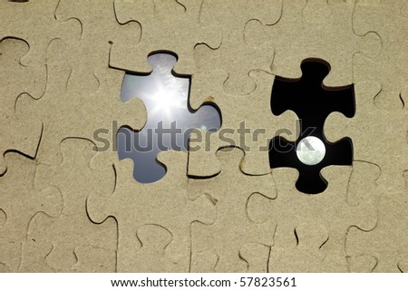 An image of a jigsaw puzzle with missing pieces with the sun and moon.