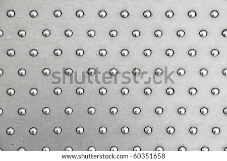 Stainless steel plate with studs.