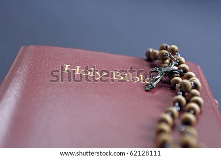 The holy bible, the rosary and a crucifix.