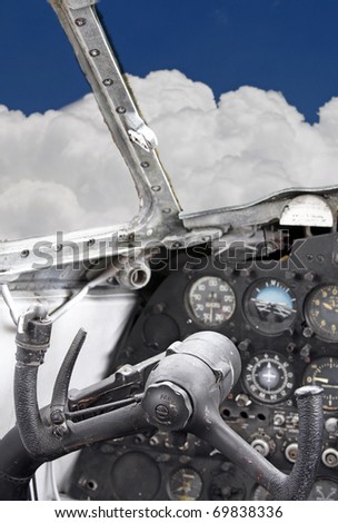 Inside the cockpit of an aeroplane showing the yoke which is the steering wheel of an aircraft, up in the sky.