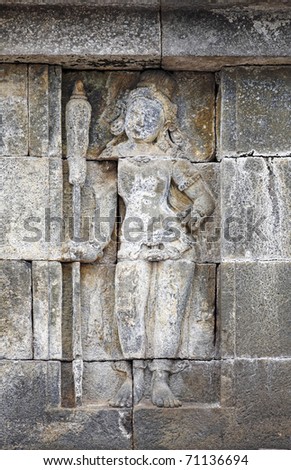 A well preserved ancient stone carving of a female courtesan on the temple wall of Borobudur temple in Yogyakarta.